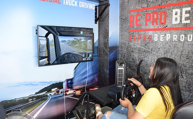 Keyry Moran tries out the truck driving simulator on the Be Pro Be Proud Mobile Workshop. (Photo by Sinclair)
