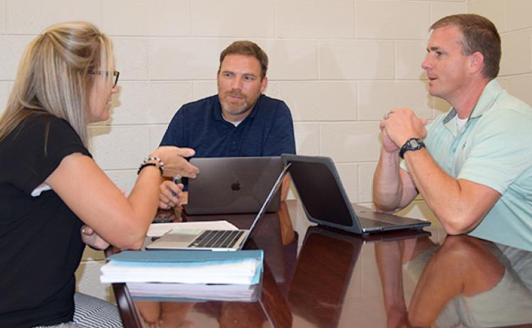 Franklin County Middle School Assistant Principal Kasey Haley, Principal Jason Swiney and Assistant Principal David Cawthon discuss ideas for a better learning experience. (Photo by Sinclair)