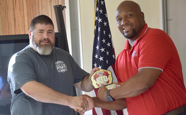 Royston Mayor Keith Turman presents the helmet badge to new Royston Fire Chief Matt Elrod. (Photos by Scoggins)