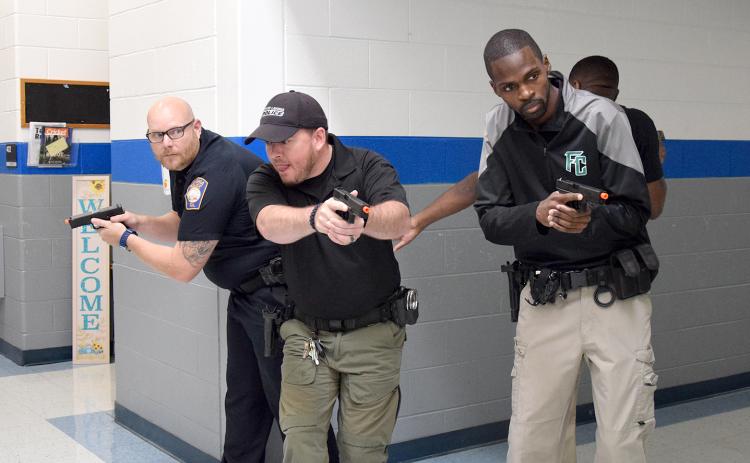 Assistant Lavonia Police Chief Daniel Carson and officers Justin Parten, Jay Thomas and Brian Neal practice a scanning technique for entering a T-shaped hallway during active shooter training Tuesday at Lavonia Elementary School. (Photo by Sinclair)