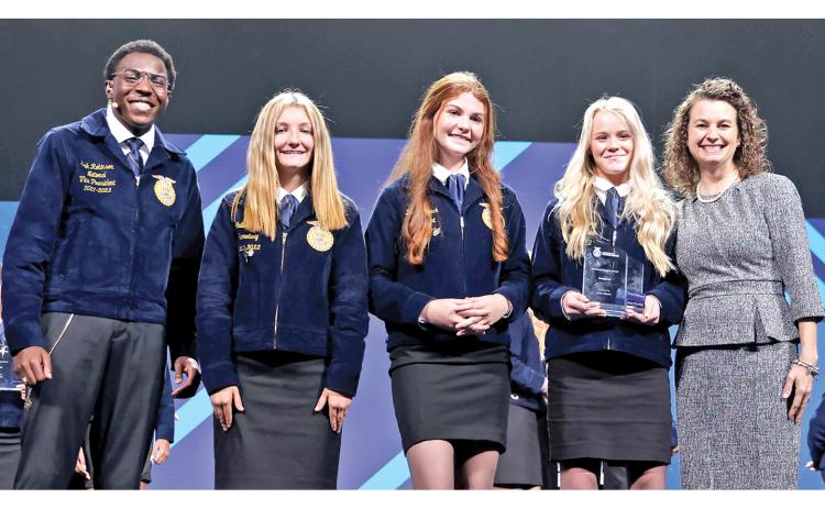 National FFA Vice President Erik Robinson presents the 2022 Middle School Model of Excellence Award to FCMS FFA chapter Secretary Callie Walker, President Darby Roach, Vice President Meghan Langley and Advisor Anna Watkins. (Photos courtesy of FFA)