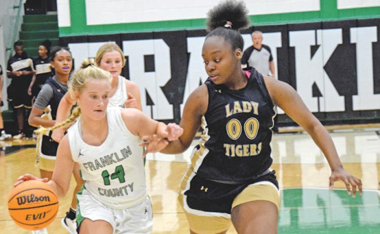 Jordis Haselton dribbles downcourt against Commerce Tuesday in the Lion’s Den. (Photo by Scoggins)