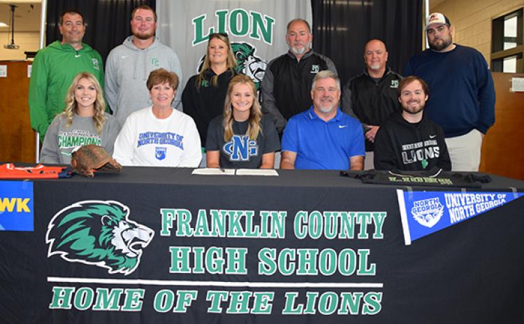 Surrounded by coaches and family, Journey Roberts signs with the University of North Georgia Nighthawks Nov. 9. (Photo by Sinclair)