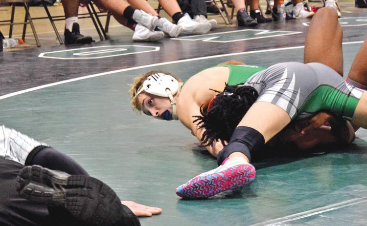 Lion Hunter Page looks to the referee for a pin in a victory over a Stephens County opponent Tuesday in the Coliseum in Carnesville. (Photo by Scoggins)
