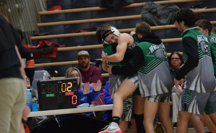 WATKINSVILLE – Will Ballenger is swarmed by his Franklin County Lion wrestling teammates Saturday after he pinned a Hart County opponent to clinch the FCHS program’s first-ever area duals championship. The Lions defeated Hart County and Stephens County two in the Area 8AAA title and will host two other teams in a state sectional Saturday at the Coliseum on Busha Road. The winner of the sectional will advance to the state duals championship tournament in Toccoa Jan. 21.
