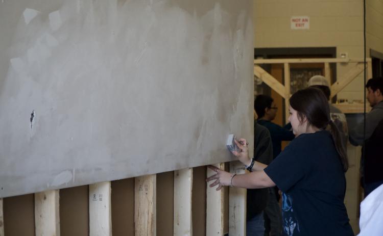 Seniors at Franklin County High School were put through a series of stations last week to learn basic life skills, including home repairs, changing a tire, personal finances and CPR. (Photos by Raese)