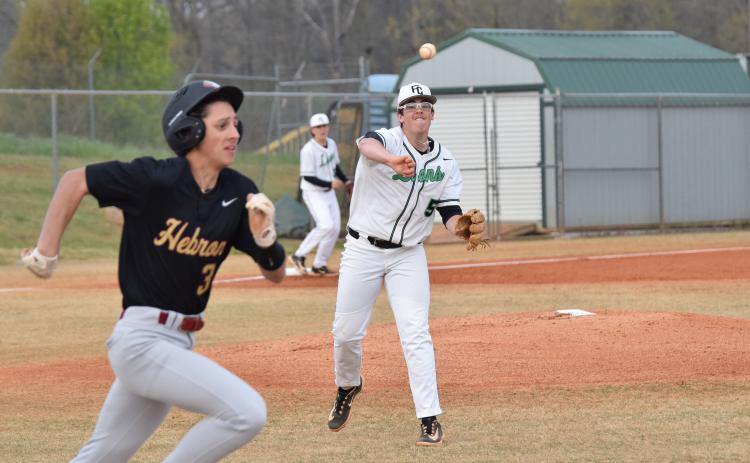 Duncan Beasley throws out a Hebron runner last week in 8AAA action. (Photos by Scoggins)
