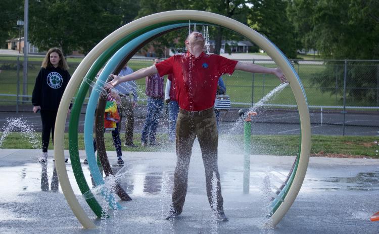 Lavonia City Council member Andrew Murphy takes in the full experience of the city’s new splash pad during a demonstration following the council’s meeting Monday night.