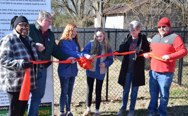 Cutting the ribbon Saturday on the new Paws & Play Dog Park are (from left) former Carnesville Council Member Patsy Watkins, former Mayor Harris Little, Kate Graham, Brooke Tate, Mayor Missy Holbrook and Council Member Wesley Dove.