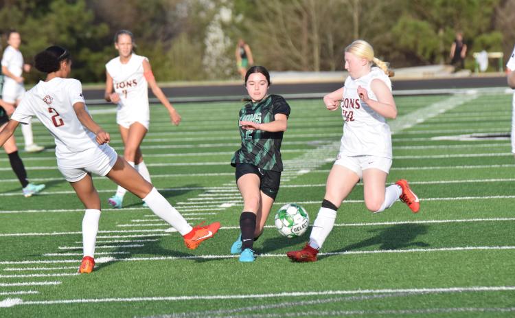 Lady Lion Brooke Davitt splits defenders during action against Hebron Christian Thursday at Jeff Davis Field at Ed Bryant Stadium. (Photos by Scoggins)