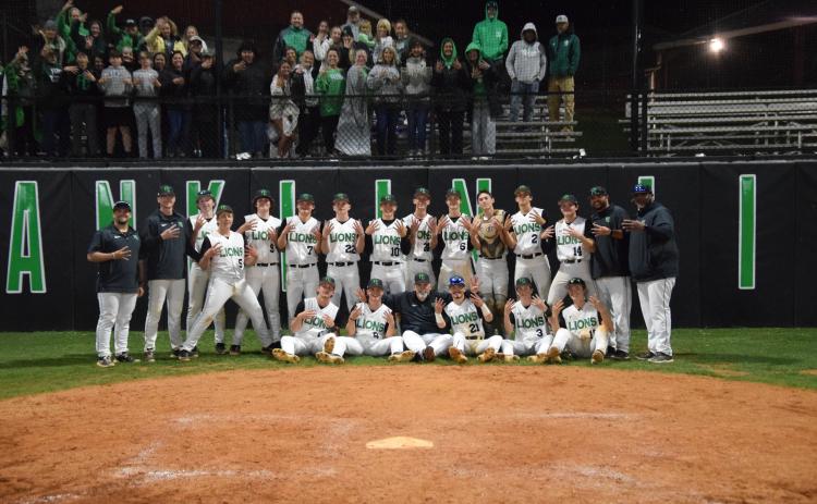 The Franklin County Lions celebrate after winning a fourth consecutive Region 8AAA baseball championship Friday in Carnesville. (Photo by Scoggins)