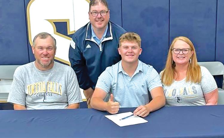 D.J. Seymour (seated center) signed a golf scholarship with Toccoa Falls College Thursday. He was joined by parents Todd and Patsy Voyles and Toccoa Falls Coach David Beddingfield.