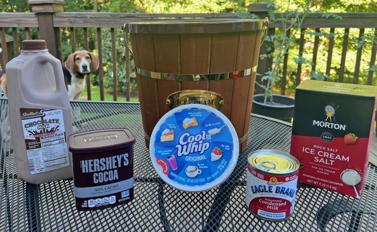 Sparky, the family’s Treeing Walker hound, spies the fixings for Tallulah chocolate on the NeSmiths’ backyard deck in Habersham County.  (Photo by Heather NeSmith)