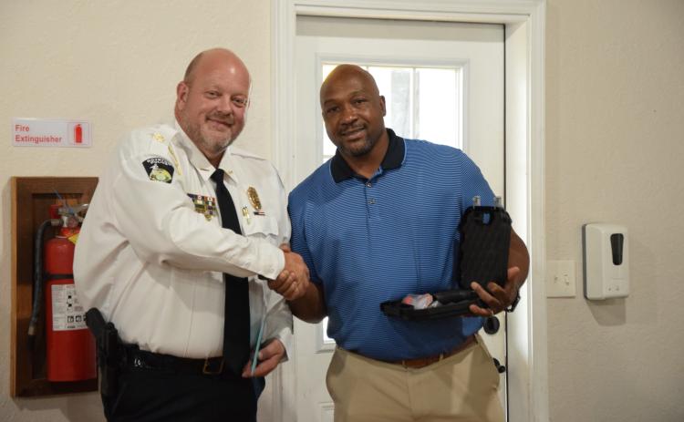 Royston Mayor Keith Turman (right) presents retiring Police Chief Donnie Bolemon (left) with a gift and his service weapon Tuesday during a reception. (Photo by Scoggins)