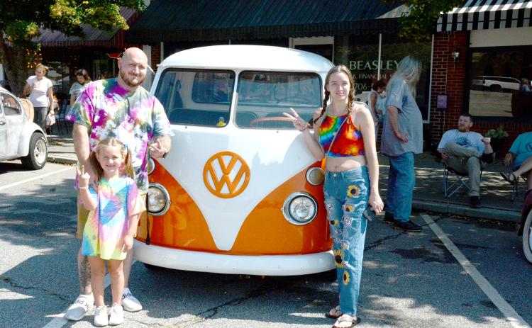 Flashing the peace sign in front of a very rare Volkswagen pickup truck are Scott Seward, Lily Seward and Bridget Cobb.
