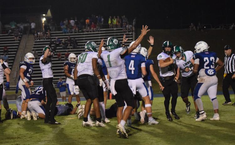 The Franklin County Lions celebrate quarterback Keyes Harbin’s (No. 33) touchdown with less than a minute to go that gave Franklin a 9-6 victory Friday over Banks County in Homer. (Photos by Scoggins)