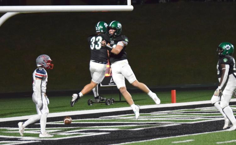 Keyes Harbin and Ramsey Fulbright (above) celebrate a touchdown Friday night during the Lions’ Homecoming game against West-Oak.