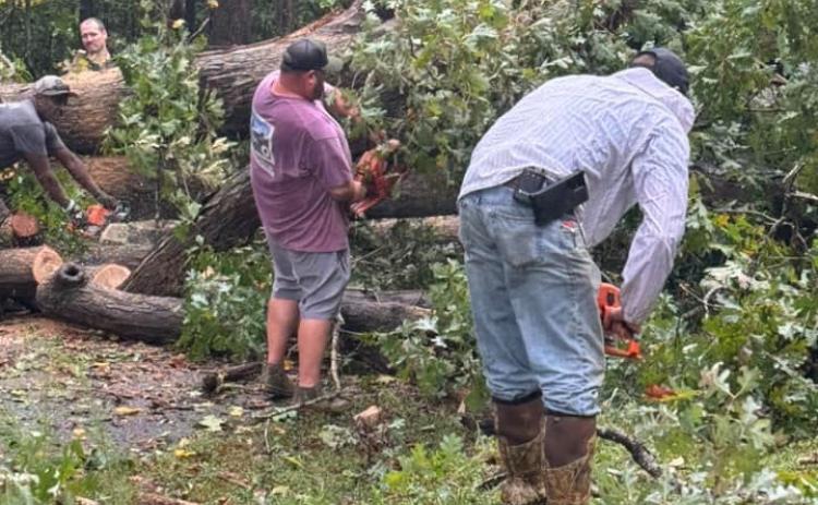 Jeremy “Bud” Fulghum and Michael Certain of Line Fire Department, with help from a Franklin County Detention Center work crew, clear a tree that fell over Burgess Road in Franklin County after the remnants of Hurricane Helene blew through the county Thursday night and Friday morning. (Photo courtesy of Ginger Fulghum)