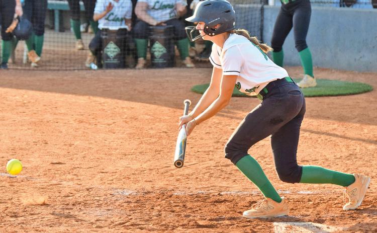 Senior Macy Moore lays down a bunt in a game earlier this season for the Lady Lions’ softball team.