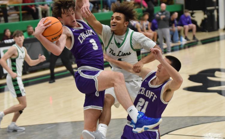 Nava Ware (right) battles two Cherokee Bluff Bears for a rebound. (Photos by Scoggins)