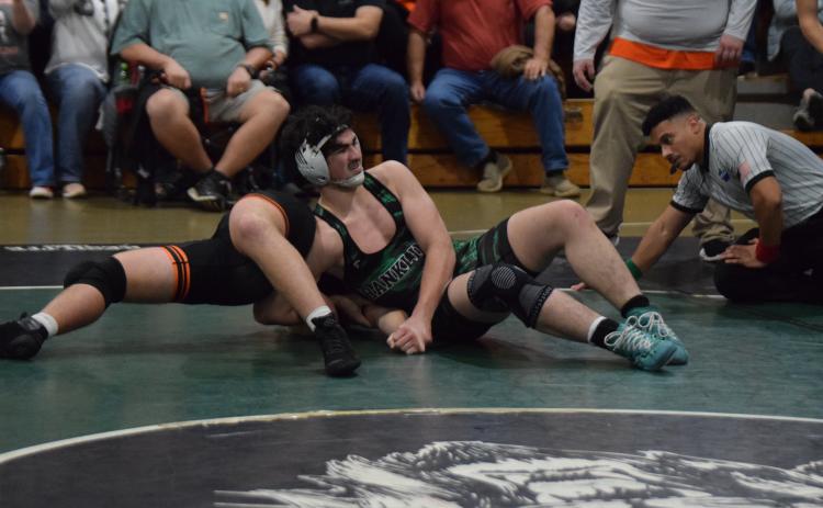 Lion Nate Stratton works to pin a Hart County opponent Tuesday in Carnesville. (Photo by Scoggins)