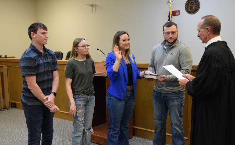 Probate Judge Ken Eavenson administered the oaths of office to newly-elected members of the Franklin County Board of Commissioners Monday. Taking the oath were incoming Commission Chairman Courtney Long (right photo), who was joined by husband Jeremy and children Nathan and Sidney; new District 2 Commissioner Cory Pulliam (below left photo), who was joined by wife Carrie; and new District 1 Commissioner Wanda Thompson (below right photo), who was joined by husband Stephen. The new commissioners will officia