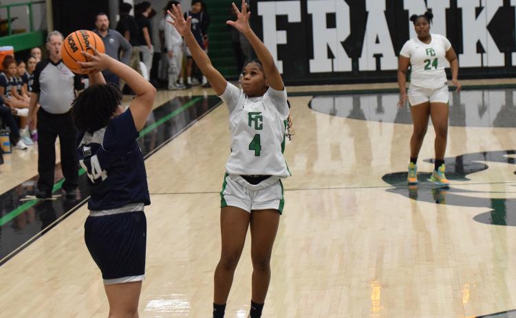 Nykhia Johnson pressures a East Jackson ball handler during Friday’s win in the Lion’s Den. Johnson made eight three-pointers in the game and finished with 27 points.