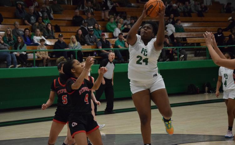 Ta’kiyah Merriett (right) collects a rebound.