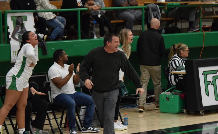 Franklin County Lady Lion Head Coach Chad Bridges (right photo, left) and Assistant Coach Bailee Breedlove react to a good play by the team in the game against Hart County. (Photo by Scoggins)