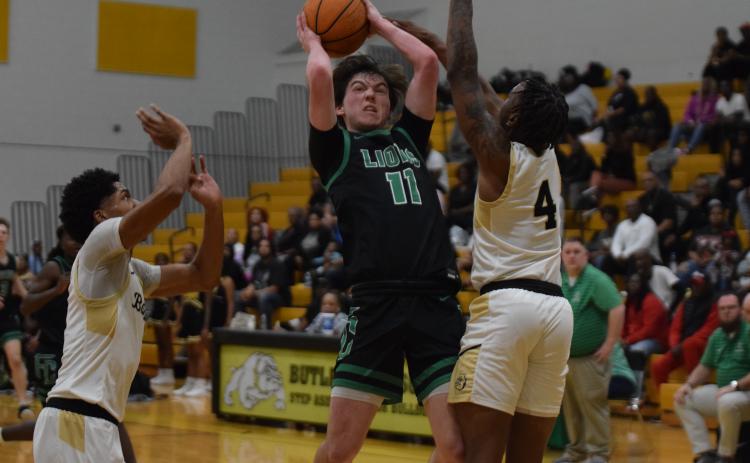 Bentley Huff (above) grabs a loose ball in action against Butler last week in the state quarterfinals against Butler in Augusta.
