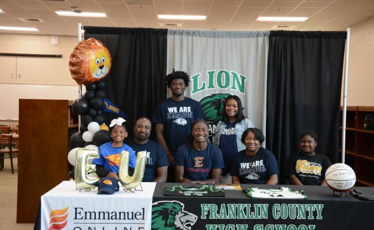 Franklin County High School senior Mylan Roebuck was surrounded by family and friends when he signed his scholarship to play basketball for Emmanuel University on Tuesday. Members of his family there for the occasion were (front, from left) Aubree Roebuck, Bernard Roebuck, Mylan, D’Anna Roebuck, Amiracle Roebuck, (back) Micah Roebuck and Alexus Burton. Mylan will join his brother Micah on the Emmanuel Lions basketball team. (Photo by Eavenson)