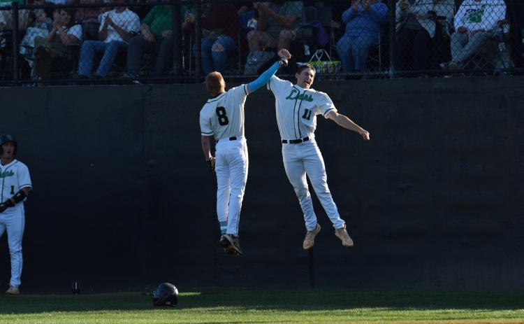 Hudson Huff (No. 9) and Will Dodd (No. 11) celebrate after Huff hit his first career high school home run April 16 against Hebron Christian. Huff, a freshman, hit the home run on Senior Night. (Photo by Scoggins)