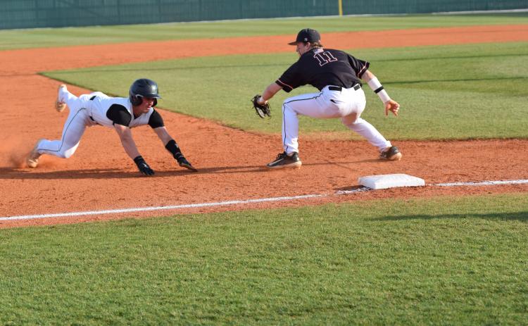 Keyes Harbin slides in safely to third in action against Hart County Friday at FCHS in Carnesville. The Lions swept the Bulldogs and have won six consecutive region contests. (Photo by Scoggins)