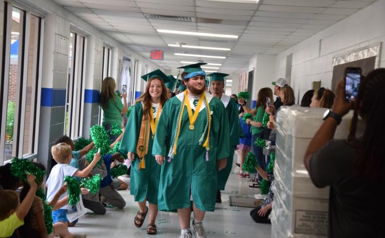 CARNESVILLE – Members of the Franklin County High School Class of 2025 will receive their diplomas Friday at Jeff Davis Field at Ed Bryant Stadium. Ceremonies are scheduled to begin at 8 p.m. In case of rain, the ceremony will be held at the Swails Center. Valedictorian Nathan Estrada (right) and Salutatorian Kayla Parker (left), pictured leading the class during the annual Lion Walk, will speak. For complete coverage of the class, see our annual Graduation Section inside. More photos from the Lion Walk are