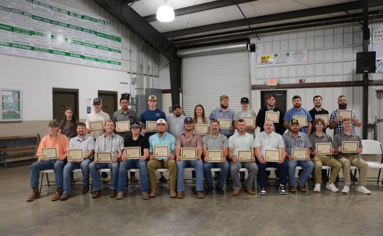 New firefighters graduating (above) from Firefighter 1 training Thursday at the Franklin County High School Ag Building are (seated, from left): Connor Anderson, Jeremey Barnes, Landon Bentley, Hunter Bruce, Landon Bruce, Preston Chandler, Joe Cheek, Brandon Coleman, Dennis Dailey, Mark Edwards, Landon Floyd, Rhett Floyd, (second row) Katie Free, Caden Jordan, Rusty King, Elijah London, James Roberts, Kayla Rogers, Ben Roper, Mallory Segars, Sam Segars, Parker Sosby, T.J. Sosby and Chris Williamson. Not pic