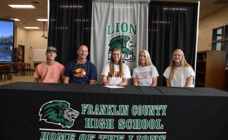 State pole vault champion Macy Moore (seated center) was joined by her family (from left) brother Eli, father Lee, mother Misty and sister Rylee at a scholarship signing ceremony at Franklin County High School. Moore will pole vault for Emmanuel University next year. (Photo by Scoggins)