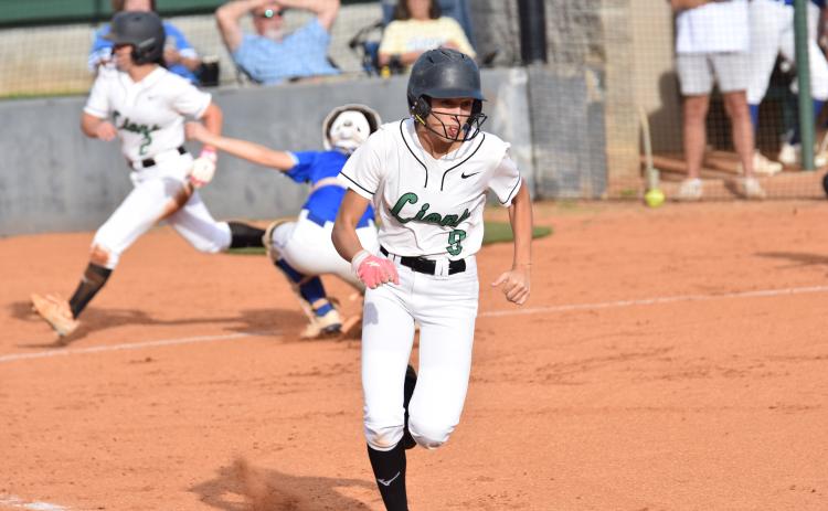 Rylee Gibson runs to first after a bunt as Hannah Horne scores behind her in Franklin’s 12-0 victory over Lake Oconee Academy Monday in Carnesville. (Photos by Shane Scoggins)