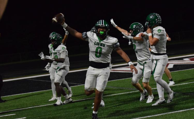 Senior D.J. Appleby comes up with a recovered fumble to end Friday night’s season opener in overtime, securing a 14-7 Franklin County Lion win over Chestatee. (Photos by Shane Scoggins)