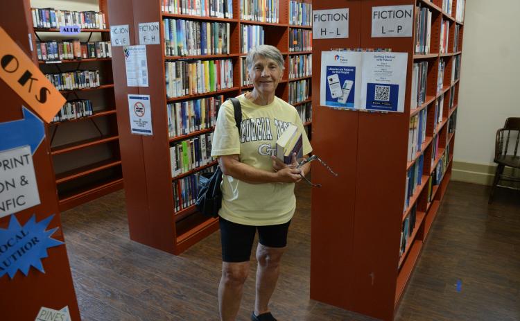Barbara Meredith, who just recently moved to the area, was making her very first visit to the Lavonia-Carnegie Library when she overheard talk of reduced hours of operation beginning in September. (Photos by Charlie Eavenson)