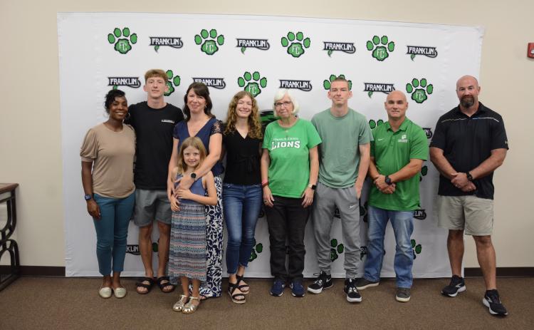 Attending the Franklin County Board of Education meeting Thursday for the naming and dedication of the system’s cross-country course as the Bill “Woody” Woods Pridelands Course are (from left) FCHS Track Coach Ann Bowman, Cole Woods, Heather Woods, Lelia Woods, Gracie Woods, Donna Barnes, Robbie Woods, Jared Hightower and FCHS Cross-Country Coach Clint Tanner. (Photo by Charlie Eavenson)