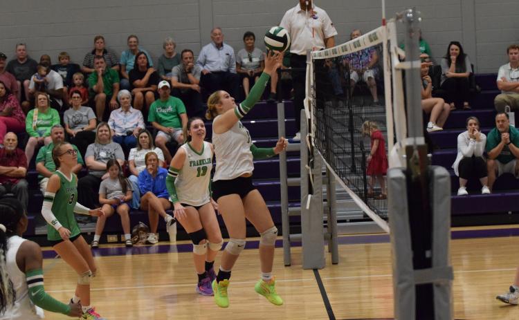 Callie Frady pokes the ball over the net in action against East Hall Thursday at South Franklin Elementary School. (Photos by Shane Scoggins)
