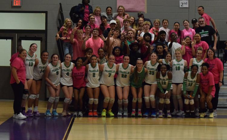The Franklin County Lady Lions volleyball team celebrate with the Rude Crew after sweeping Stephens County in the first round of the Region 8AA tournament Tuesday at South Franklin Elementary School. The win secured a state playoff berth for FCHS for the first time in school history. (Photo by Shane Scoggins)