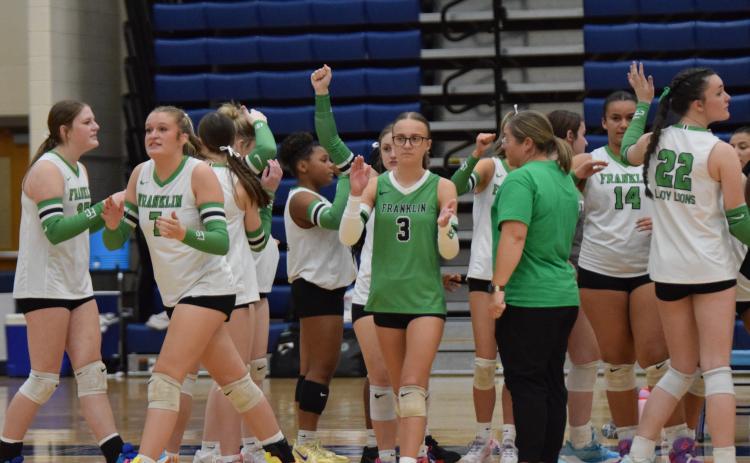 Enslee Stowers (No. 3) and Callie Frady (No. 7) lead the Lady Lions out of a timeout during Saturday’s state semifinal match against Ringgold in Marietta.