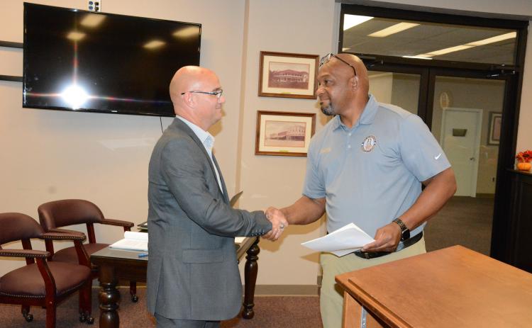 Royston Mayor Keith Turman (right) shakes hands with new Council Member Jared Hightower Tuesday after a swearing-in ceremony at Royston City Hall. Hightower then joined the council for its regular monthly meeting. (Photo by Charlie Eavenson)