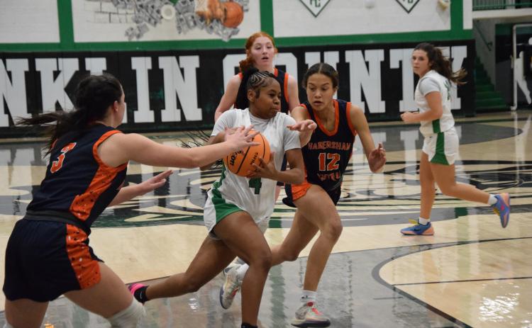 Lady Lion Nykhia Johnson drives toward the basket in action last week against Habersham Central in the Lion’s Den. Johnson finished with eight points. (Photo by Shane Scoggins)