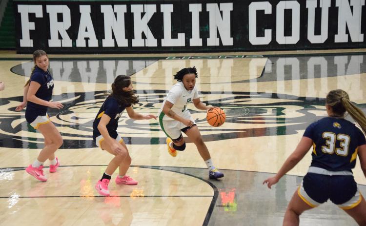 Ta’Kiaha Winkfield drives past a Prince Avenue defender in Friday’s Franklin County win over the Lady Wolverines. The game was Winkfield’s season debut after missing the start of the season due to injury. (Photos by Shane Scoggins)