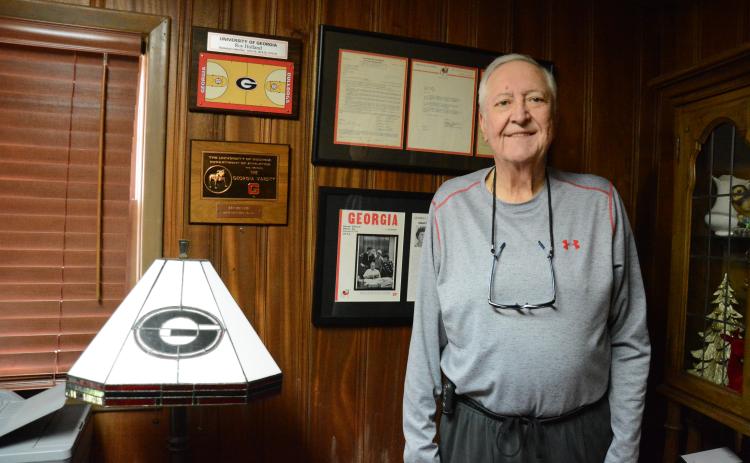 Roy Holland of Lavonia stands with some of his awards and honors he garnered as a basketball letterman for the University of Georgia Bulldogs. (Photo by Charlie Eavenson)
