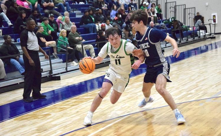Bentley Huff drives past a Prince Avenue defender in Franklin County's Region 8AA semifinal win Wednesday night in Bogart.