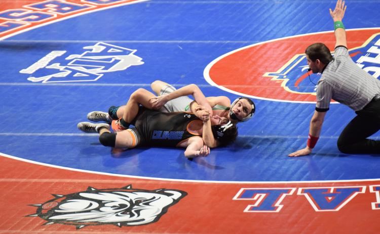 Franklin County Lion Josh Baughcum wraps up an opponent during his run to the Class AA 150-pound state championship. (Photo by Shane Scoggins)