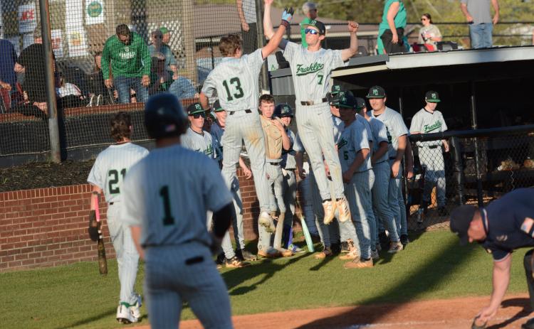Gavin Holman (No. 13) and Eli Moore (No. 7) celebrate after Holman’s home run against Hart County Monday in Hartwell. (Photo courtesy of Benjamin London of The Hartwell Sun)